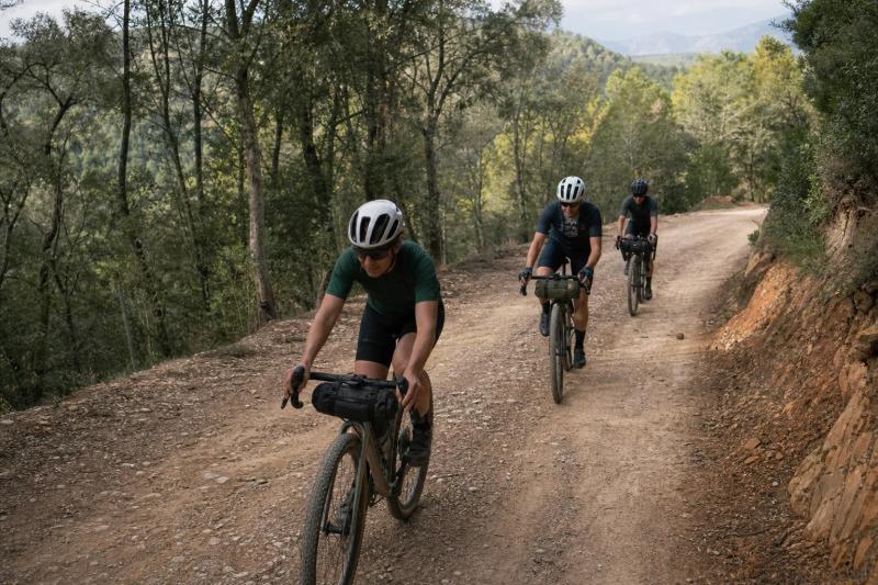 Group climbing a shaded forest track on the Forest Gravel Loop